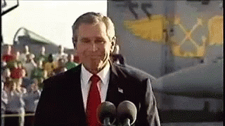 A gif of George W. Bush on an aircraft carrier, a banner unfurls behind him saying 'Mission Accomplished' it's not clear what mission was accomplished.